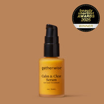 A bottle of Gatherwise Calm & Clear Serum with a black pump dispenser and amber-yellow liquid, set against a solid warm brown background with a Beauty Shortlist Awards 2025 badge is displayed in the upper right corner.