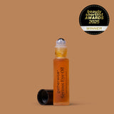 A bottle of Gatherwise Serious Eye Oil with its cap off, set against a solid warm brown background, featuring a Beauty Shortlist Awards 2025 badge is displayed in the upper right corner.